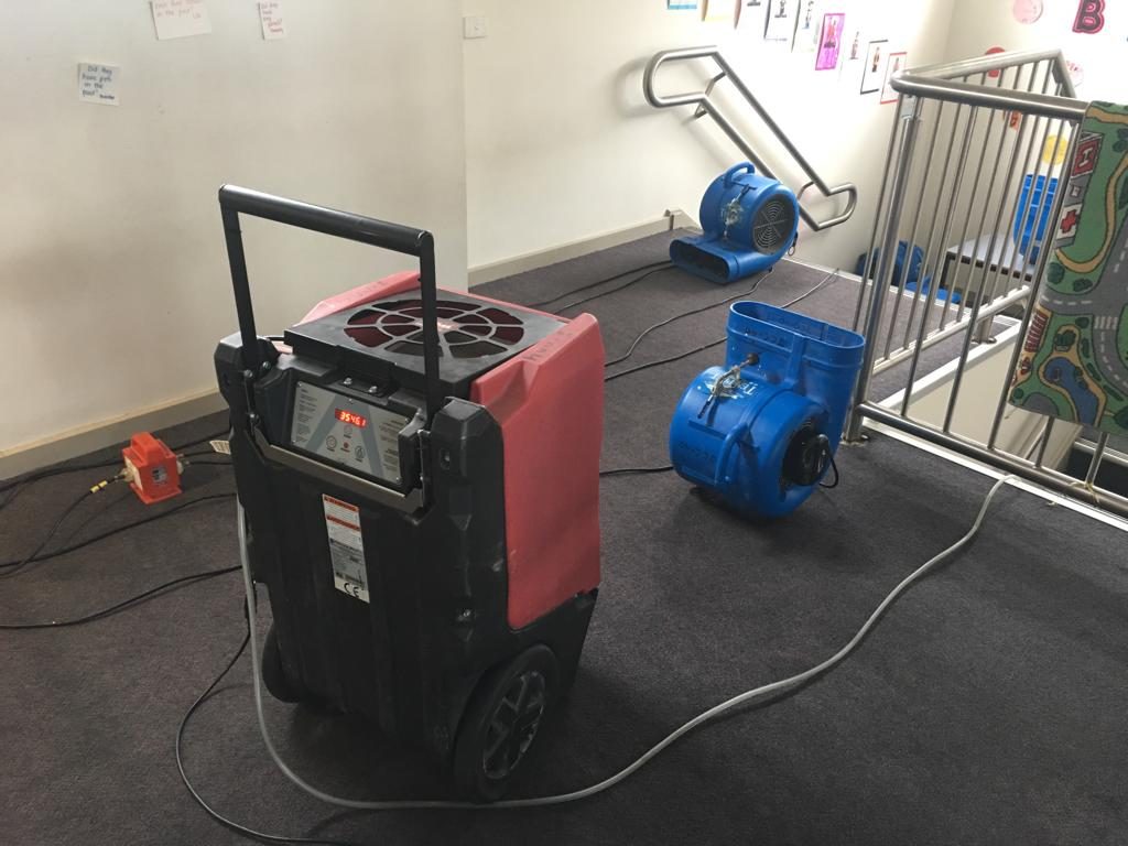 water damage carpet cleaning and ceiling drying in school